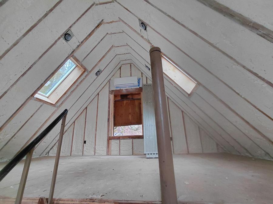 Spray foam between the rafters of a loft with skylights, Oxford, CT
