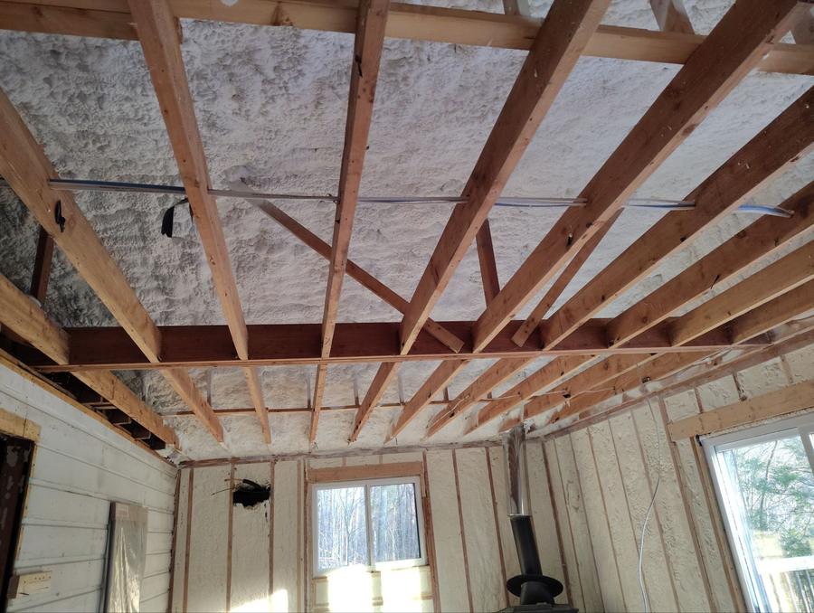Spray foam sprayed between the roof rafters above open ceiling framing, Neversink, NY