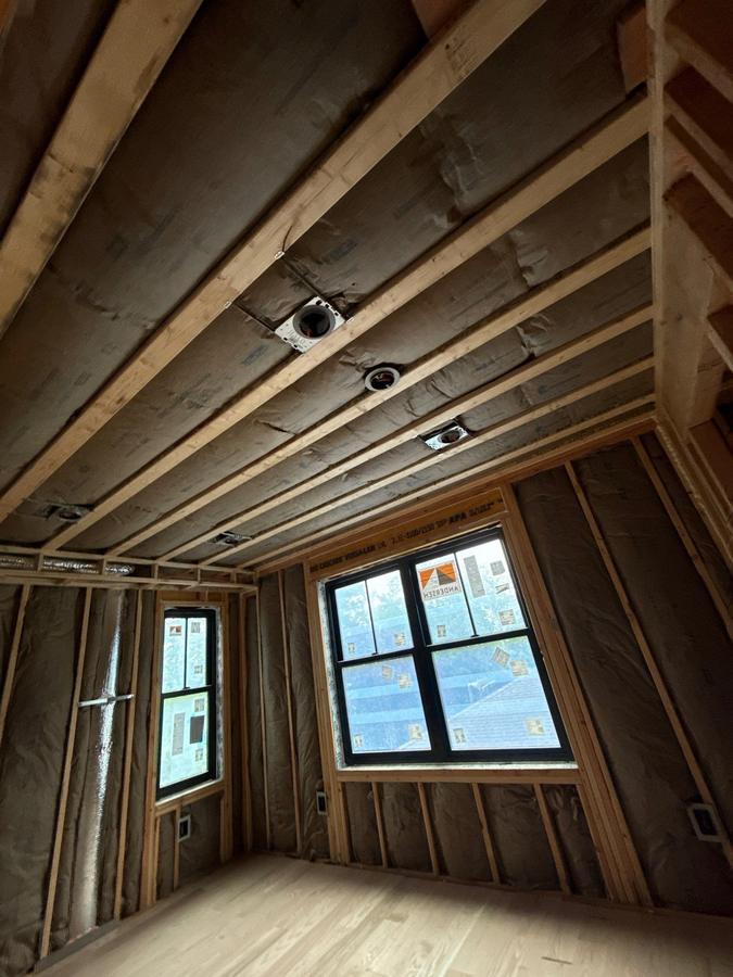 Insulation batts fitted between the ceiling joists and wall studs, Millburn, NJ