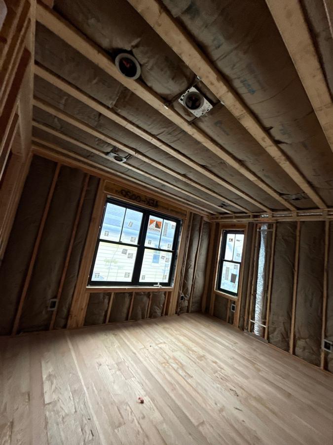 A bedroom with batts installed across the walls and ceiling, Millburn, NJ