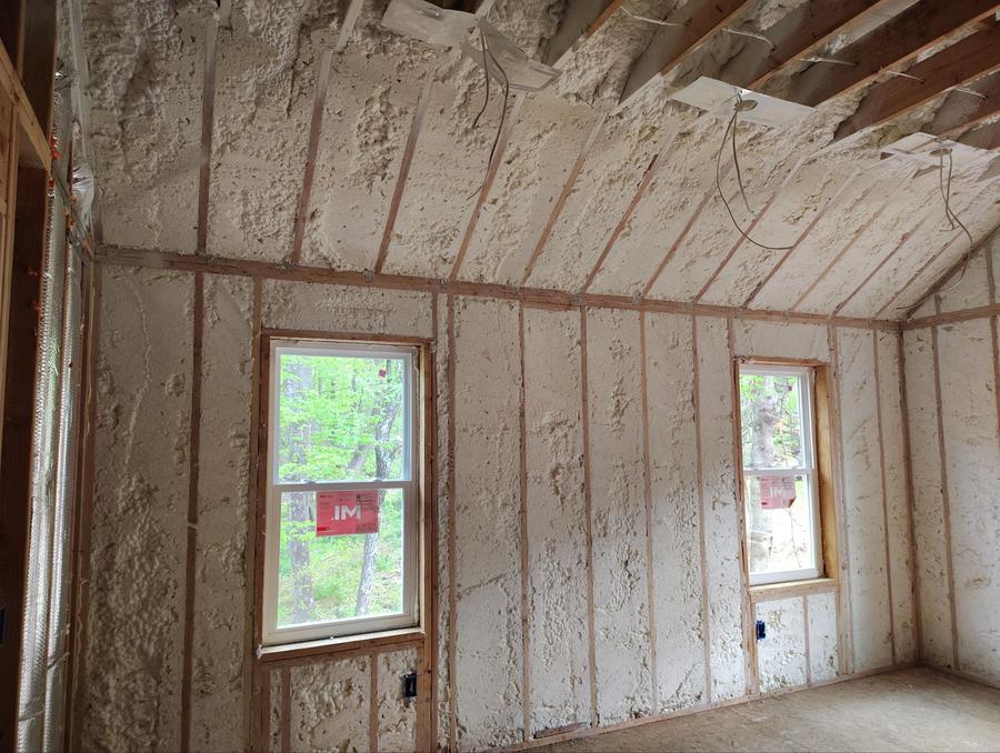 Spray foam covering the walls and sloped ceiling of an upper room, Katonah, NY