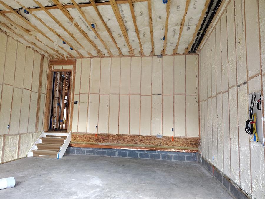 Spray foam filling every wall and ceiling bay in a lower-level room, Paramus, NJ