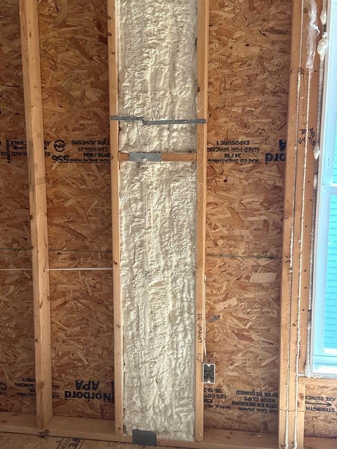Spray foam filling a full-height stud bay in an exterior wall, Simsbury, CT