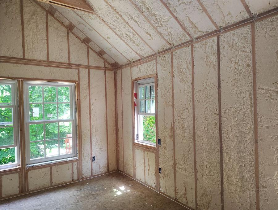 Spray foam covering the walls and sloped ceiling of a gable room, Scarsdale, NY
