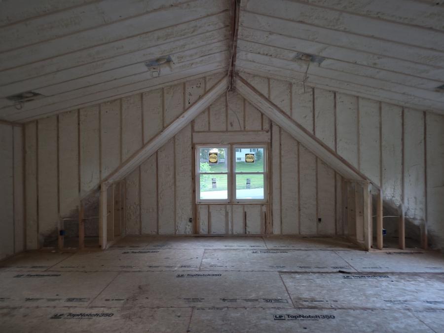 Spray foam covering the rafters and gable wall of an attic room, Fishkill, NY