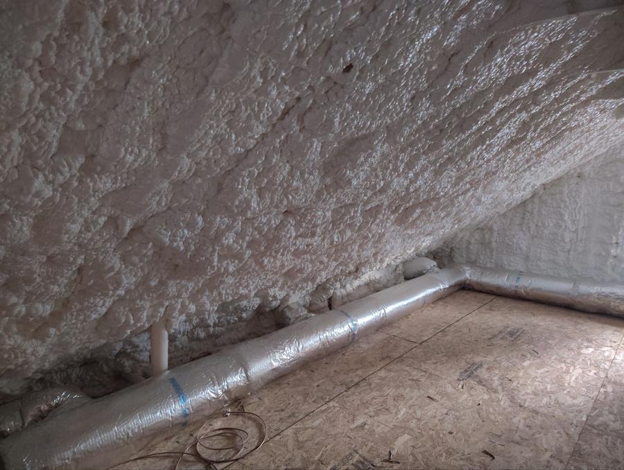 Close view of spray foam filling the roof slope above the ductwork, Scarsdale, NY