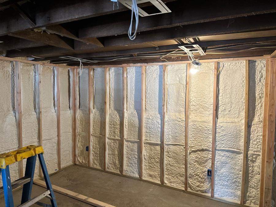 Spray foam filling every stud bay along a basement wall, Briarcliff Manor, NY