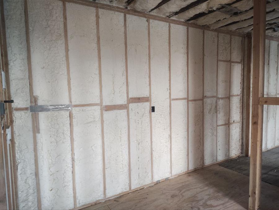 Spray foam filling the wall cavities along a long exterior wall, Newark, NJ