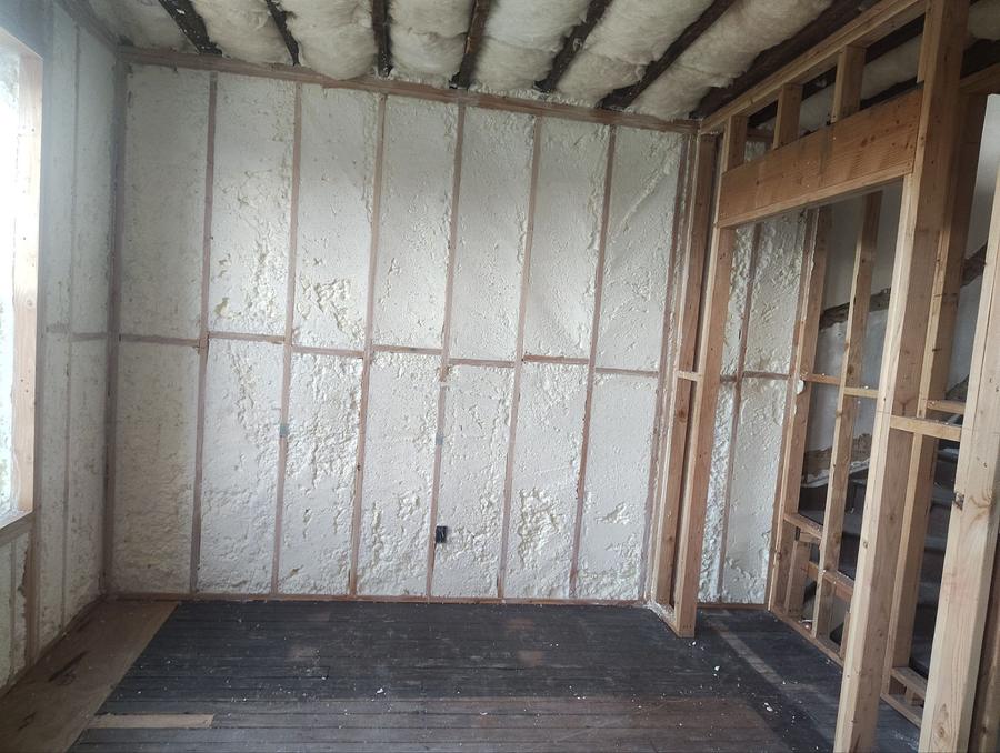 Spray foam covering the walls and ceiling of a gutted room, Newark, NJ