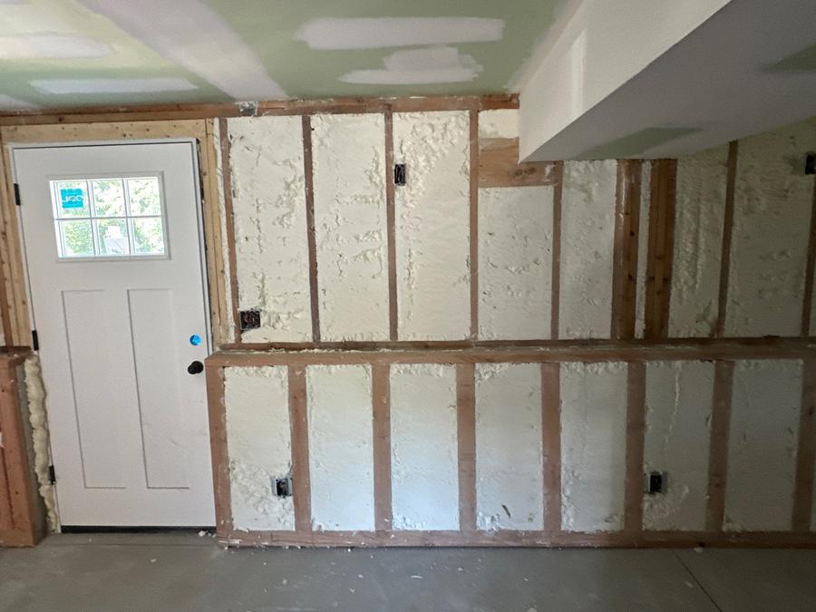 Spray foam filling the stud bays beside a door, Danbury, CT