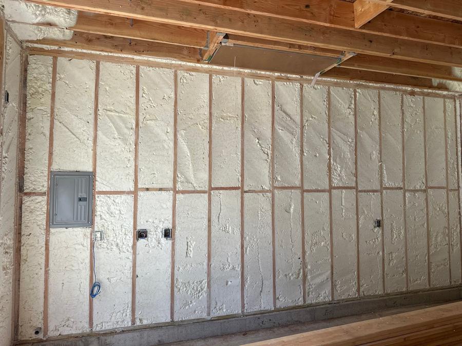 Open-cell foam filling every stud bay along a long wall, Pelham Manor, NY