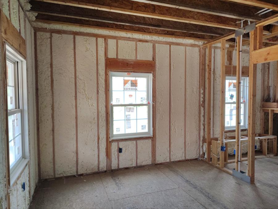 Spray foam filling the exterior wall cavities around a window, Madison, CT