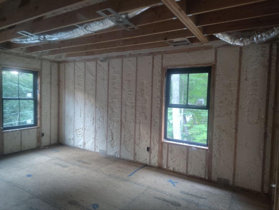 Spray foam filling the exterior walls between two windows, Amawalk, NY