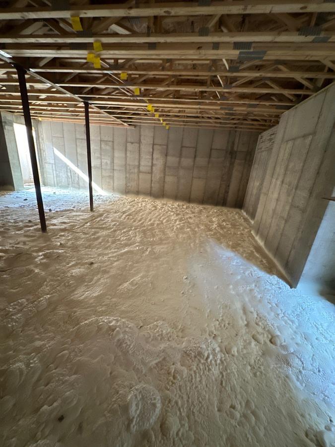 Spray foam covering the basement floor between the support posts, Brewster, NY
