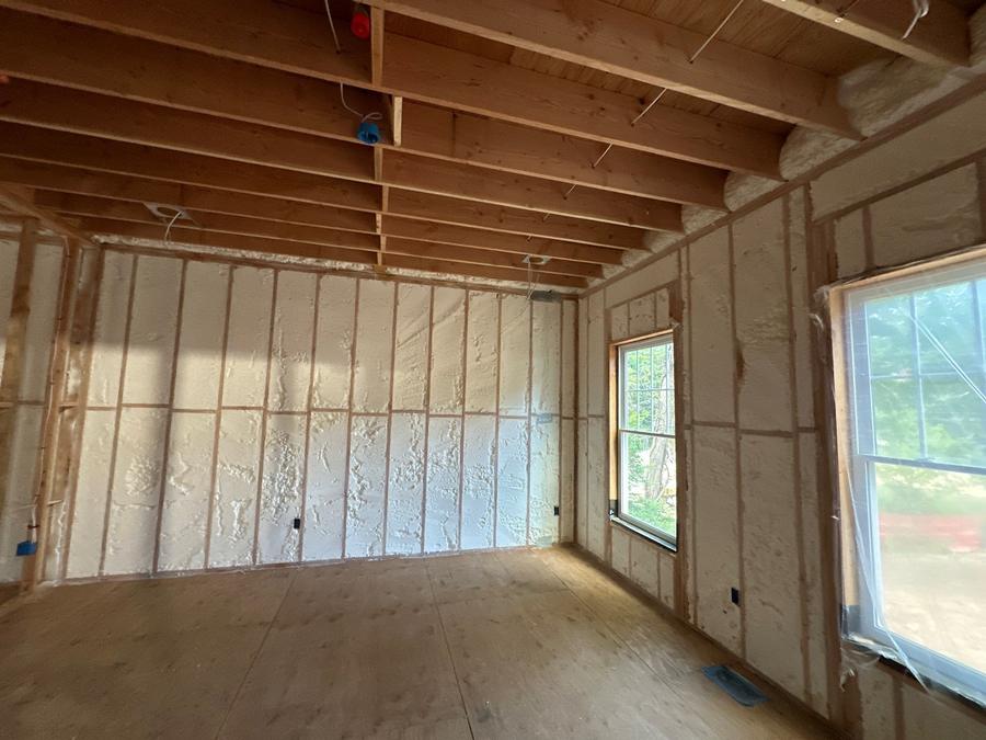 Spray foam filling the exterior wall cavities of a framed room, Tarrytown, NY