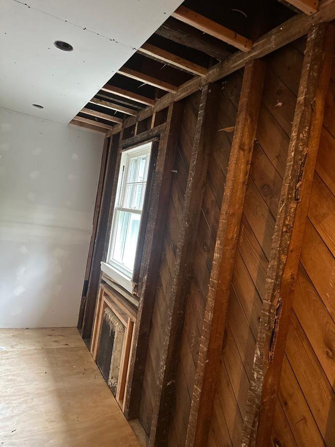 Before: open wall cavities against the old board sheathing, Pelham, NY