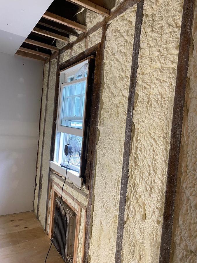 After: the same wall filled with spray foam around the window, Pelham, NY