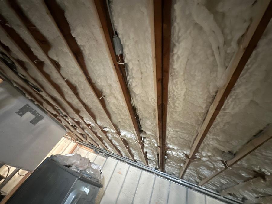 Spray foam filling the joist bays of the basement ceiling, Great Neck, NY