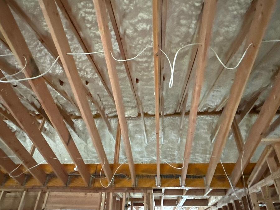Spray foam sealing the roof deck between the rafters, Brightwaters, NY