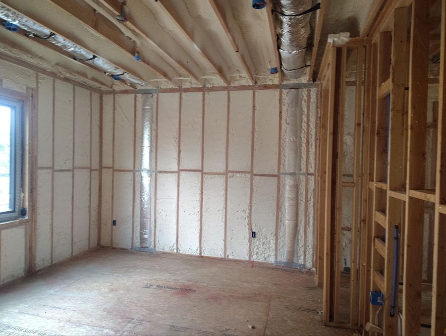 Spray foam filling the exterior wall cavities of a framed room, Guttenberg, NJ