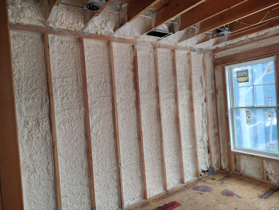 Spray foam filling the exterior wall cavities beside a window, Old Saybrook, CT