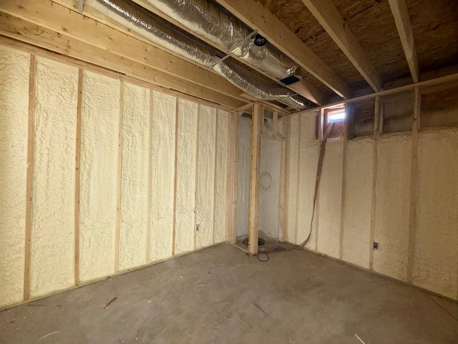 Spray foam behind the ductwork on a basement wall, Bristol, CT