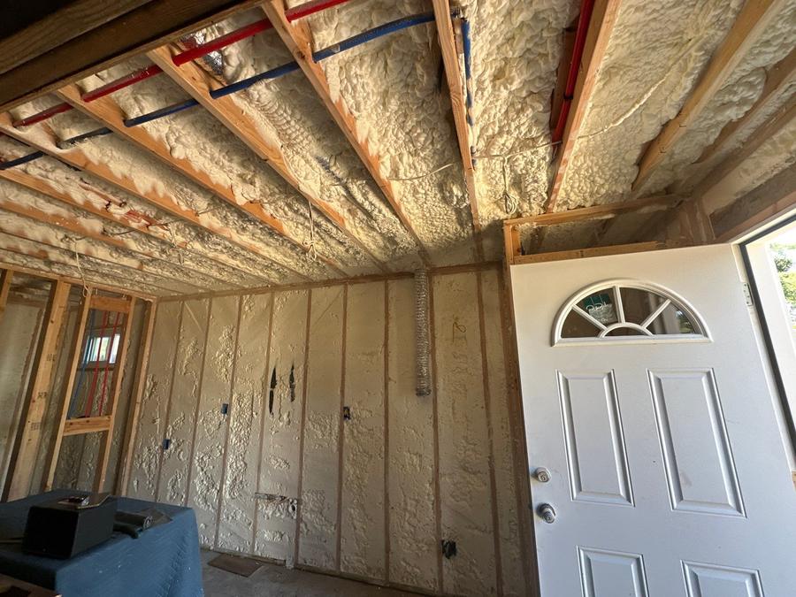 Foamed ceiling and wall cavities beside an entry door, Central Islip, NY