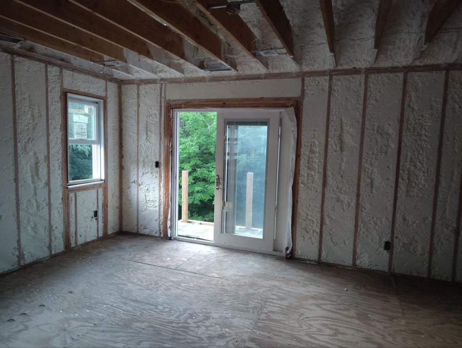 Spray foam filling the walls around a door and window, Newtown, CT