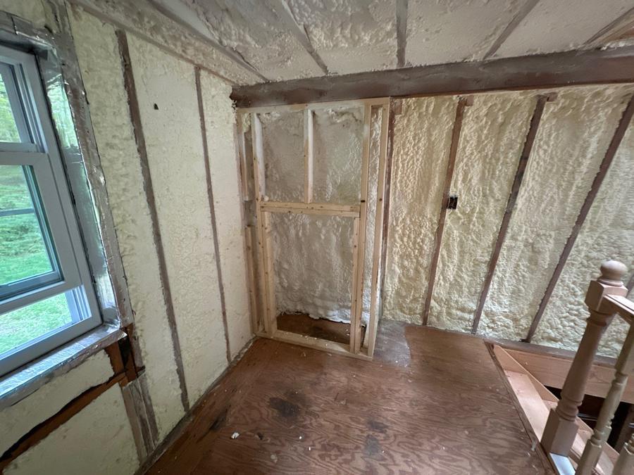 Foamed knee wall and sloped ceiling beside a window, Cortlandt Manor, NY