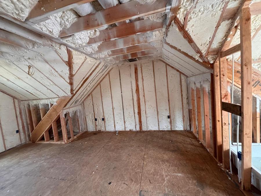 Spray foam covering the roofline and walls of an upper room, Stamford, CT