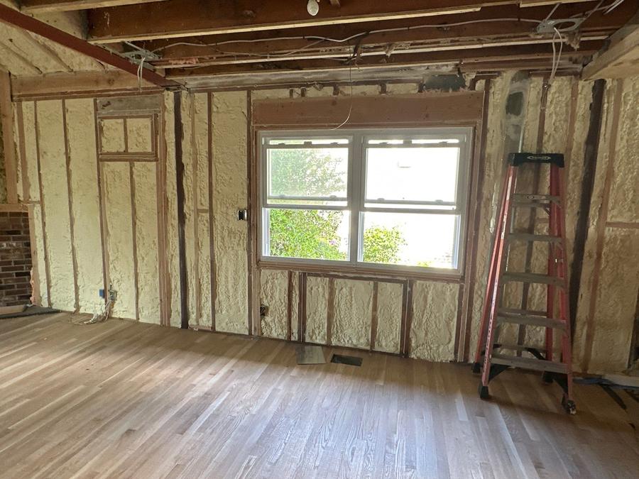 Spray foam filling the wall cavities around a window, Eastchester, NY
