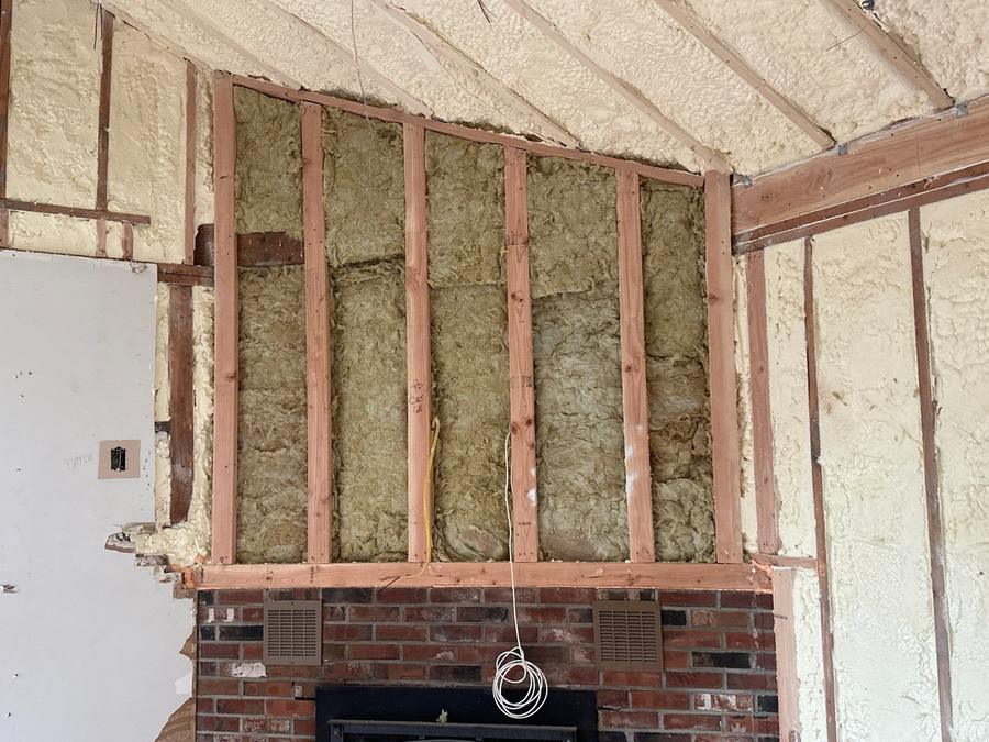 Batts in the wall above a fireplace beside a foamed ceiling, Eastchester, NY