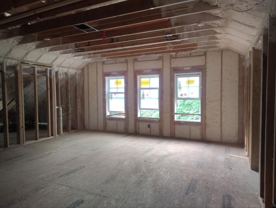 Foamed walls and sloped ceiling in a large room, Harrison, NY