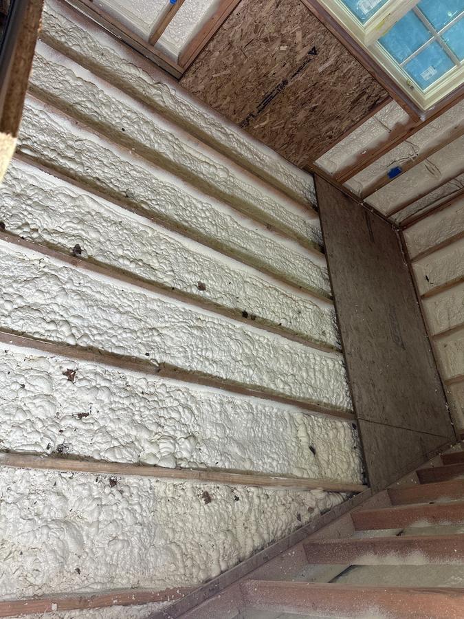 Close-up of spray foam filling the sloped ceiling bays, Bronxville, NY