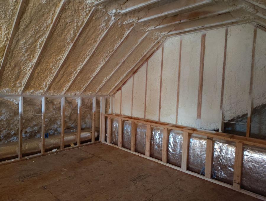 Spray foam sealing the attic roof deck above foil-faced knee walls, Greenwich, CT