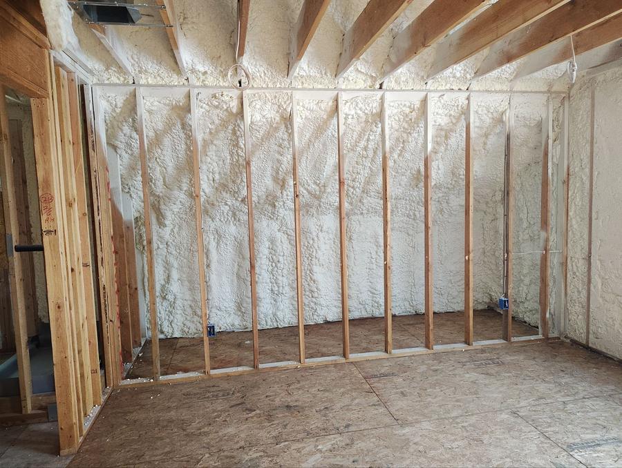 Spray foam filling the wall cavities between exposed studs, Greenwich, CT