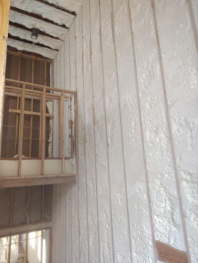 Foamed wall cavities rising alongside a framed balcony, Plymouth, CT