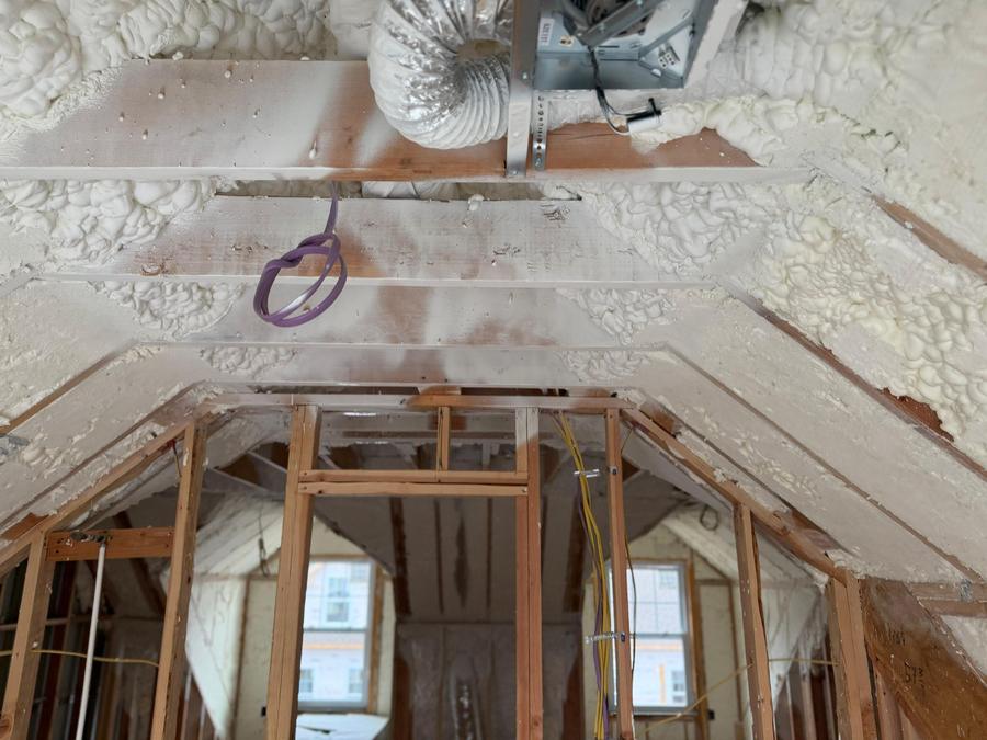 Spray foam sealing the roof deck around ductwork, Stamford, CT