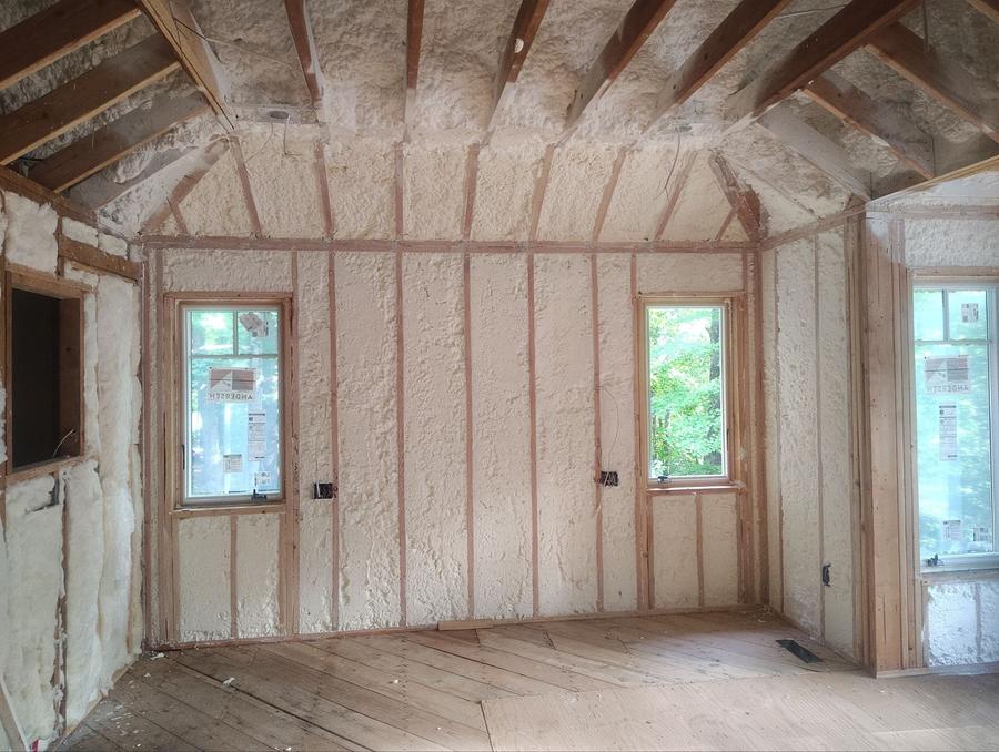 Spray foam covering the walls and sloped ceiling of a room, Bedford, NY